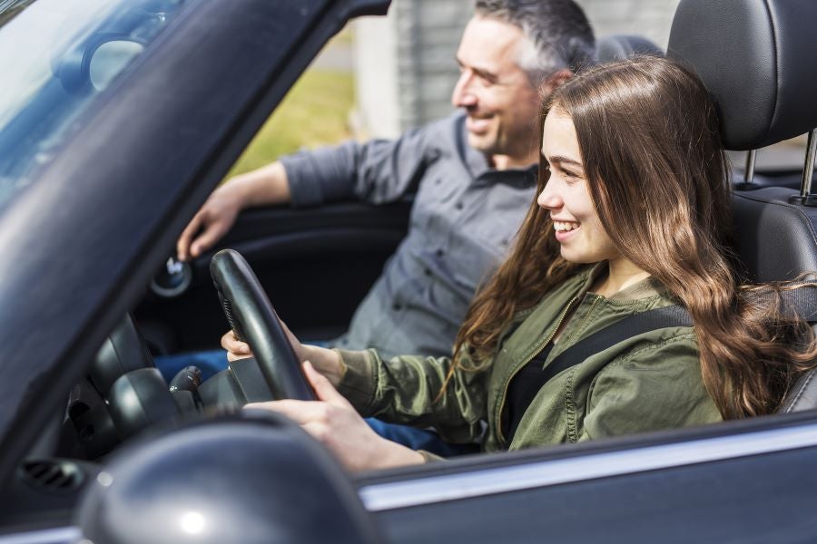 Woman with her father in a brand new car